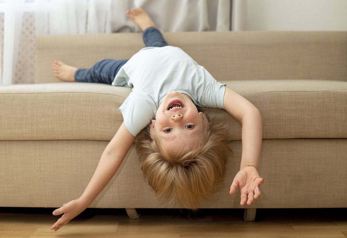 a kid lying reverse on the couch a kid lying reverse on the couch