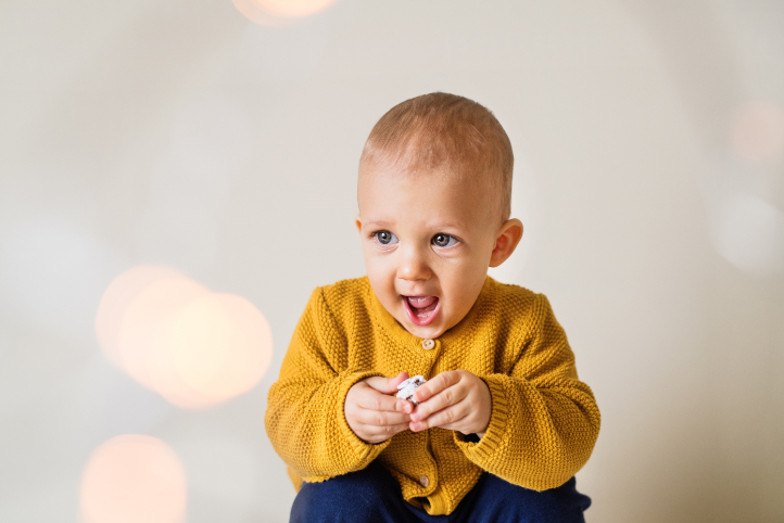 Mutlu sarı kazaklı bir bebek Happy baby wearing a yellow sweater